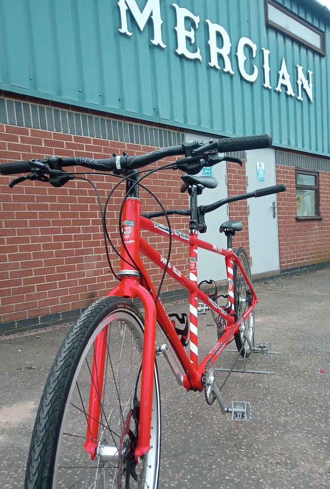 Greg James Comic Relief Red Tandem bicycle outside Mercian Derby workshop
